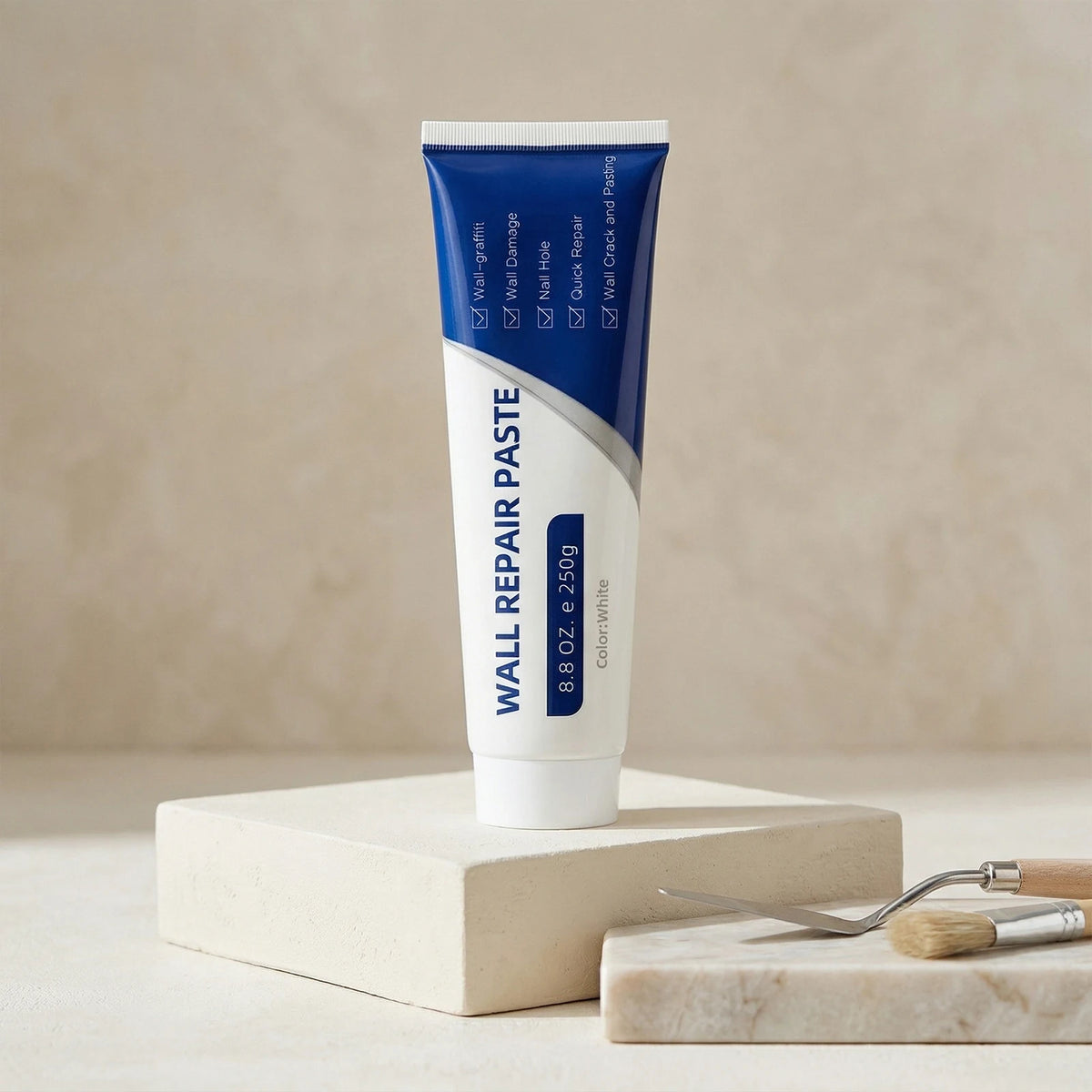 A tube of Wall Repair Paste in blue and white packaging is displayed on a light wooden block.