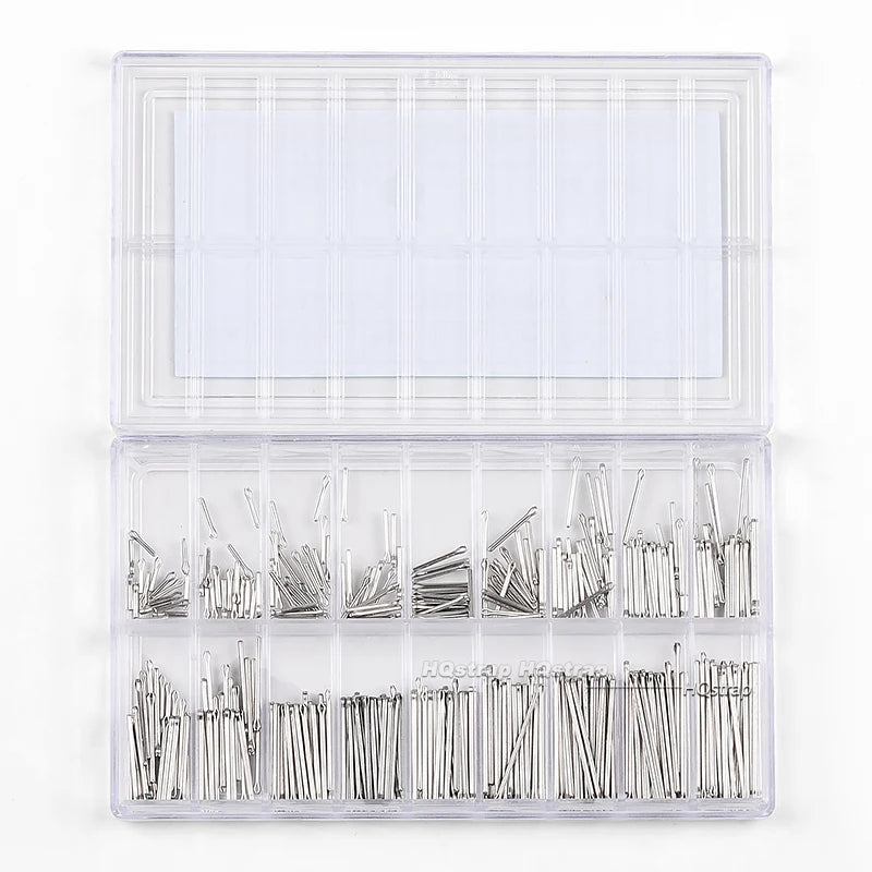 A clear plastic box containing a set of stainless steel watch band split pins and connecting links.