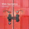 A close-up of a black stainless steel barn door lock installed on a red wooden door.