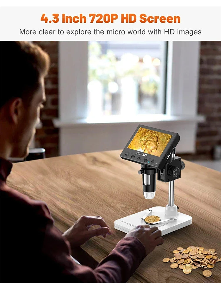 A person is using a 4.3 inch 720P HD digital microscope to examine small objects like coins on a wooden table.