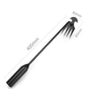 A black multifunctional hand weeder tool with a long handle and a pronged tip.