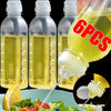 Six squeeze dispenser bottles of yellow liquid seasoning next to a lemon and salad ingredients