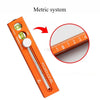 Orange extendable multifuction scribing level ruler showing a measurement scale.