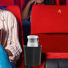 A black cup holder rack is placed in a red chair, with a person's arm visible nearby.