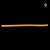 A small, elongated, golden-brown object used for ring sizing adjustment.