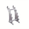 Clear plastic ballpoint pen holder organizer with a decorative, leaf-like design.