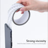 A hand is applying heavy duty self-adhesive mesh repair tape to a smartphone screen.