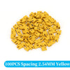 A pile of 100 yellow spacing jumper cap connectors for through hole applications.