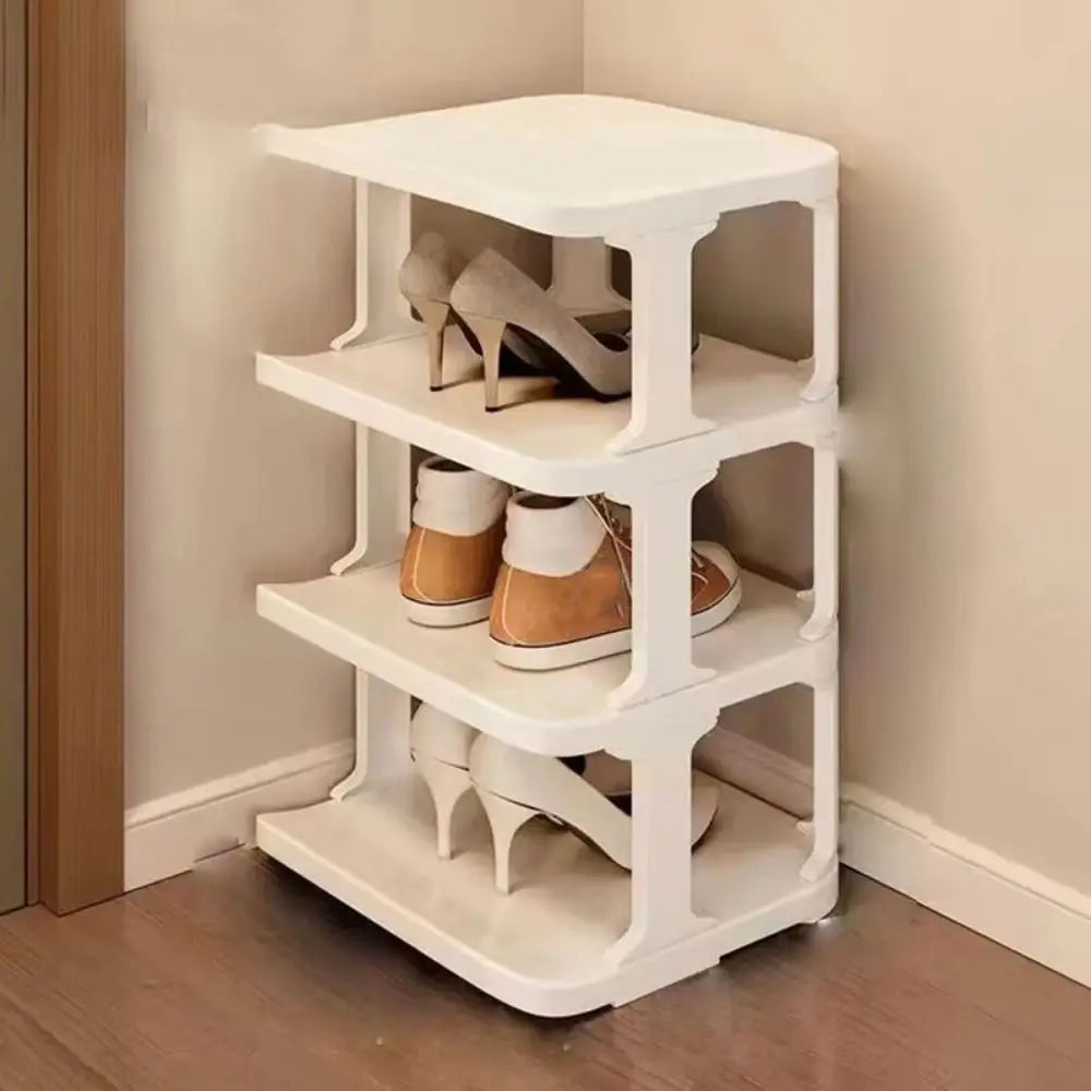 A white stackable vertical shoe rack organizer with four tiers holding various pairs of shoes.