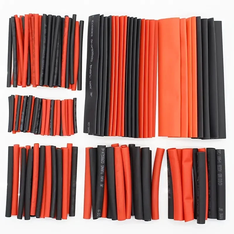 A collection of black and orange heat shrink tubing for wire insulation and protection.