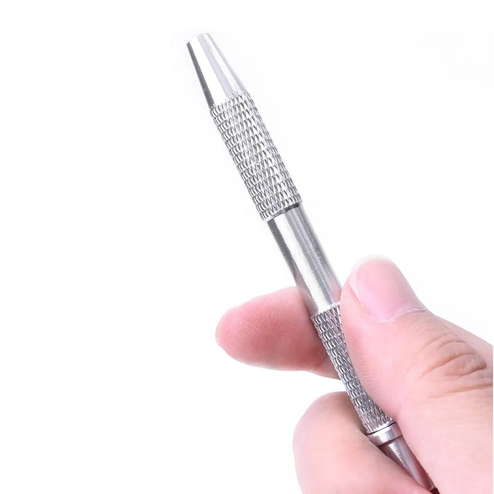 A hand is holding a silver precision 4-prong gem and small parts grabber tool.