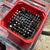Red plastic organizer insert holding various screwdriver drill bits.
