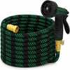 A coil of black garden hose with green accents and a spray nozzle attached to the end.