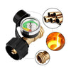 A propane tank pressure gauge with a black housing and brass fittings, showing pressure readings.
