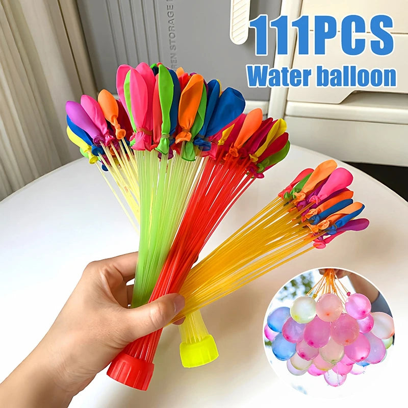 A hand holds a bundle of 111 colorful water balloons in various shades of pink, orange, blue, and green.