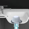 A close-up view of a silver faucet mounted on a white sink, with a mesh hair catcher protector installed below.