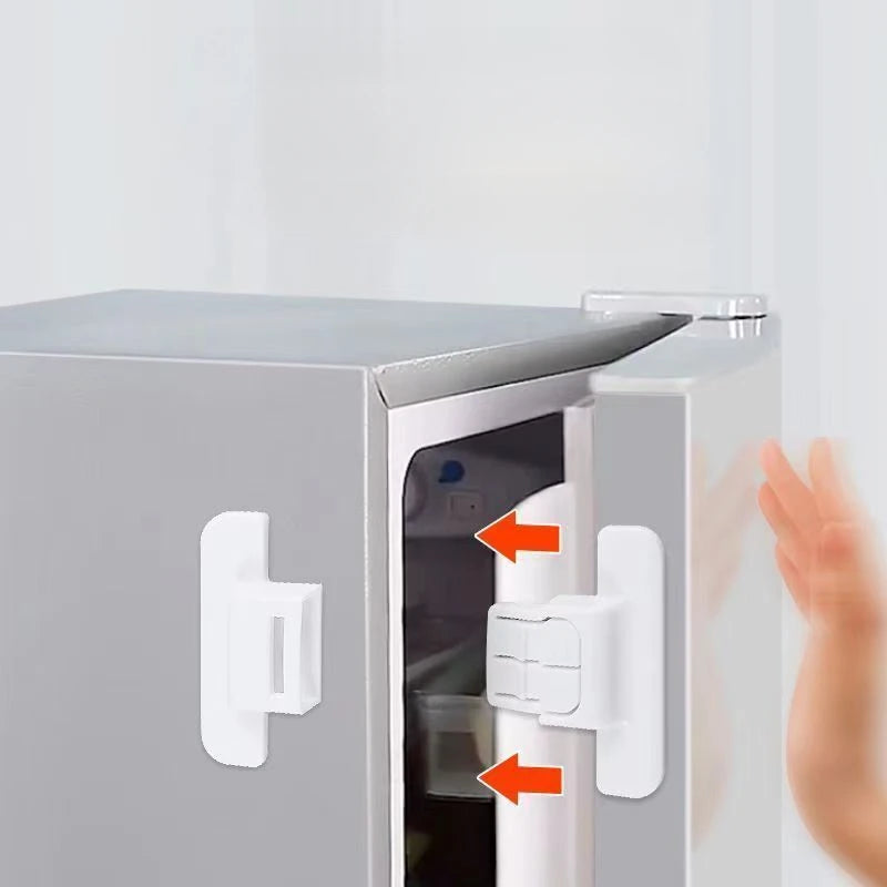 A close-up view of a refrigerator door with white safety locks installed on the frame and door.