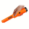 A hand is holding an orange GP-Pointer handheld metal detector with a black tip.