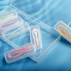 A clear plastic kit containing five pairs of contact lens tools and lenses on a blue background.