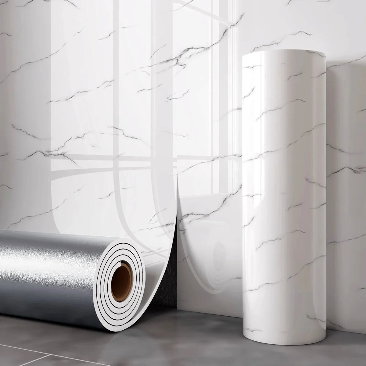 Roll of white marble wall decals displayed next to a rolled silver material on a gray floor.