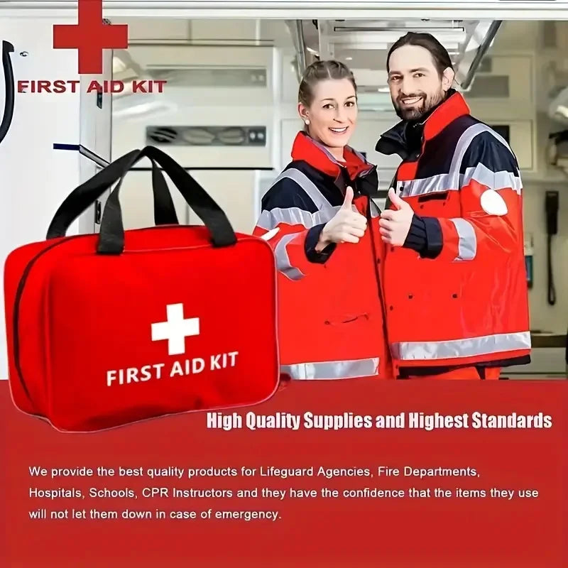 A red first aid kit bag next to two people wearing emergency response jackets.