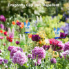 Dragonfly clip bug repellent featuring iridescent green and blue dragonfly clips among colorful flowers