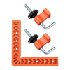 A set of orange 90 degree precision corner clamps for woodworking, including various metal and plastic components.