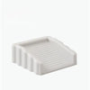 A white reusable TPR door stop wedge with ribbed texture.
