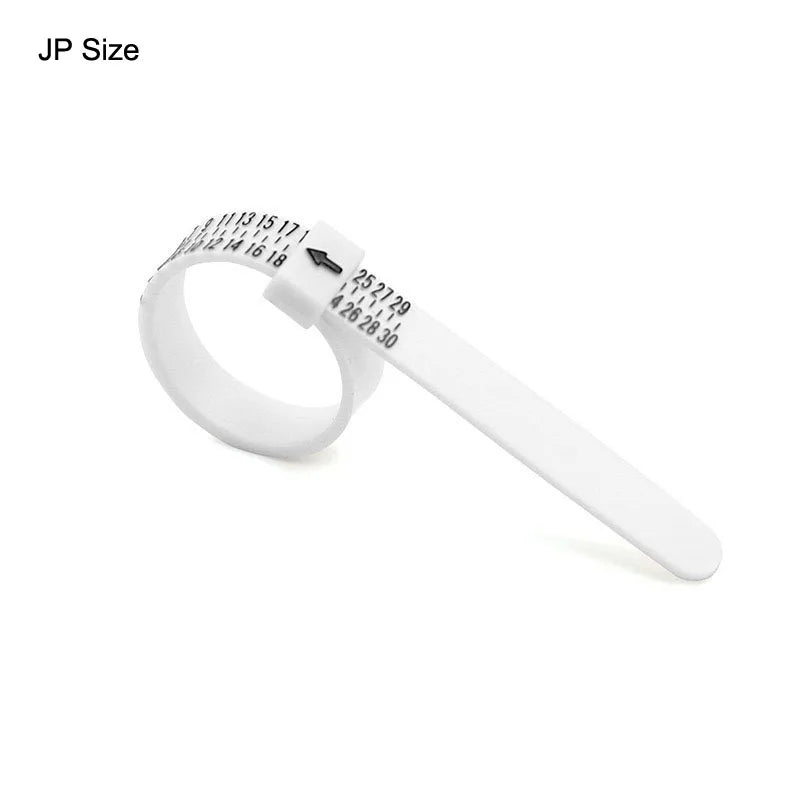 A white plastic ring sizer with numbered markings for measuring jewellery size.