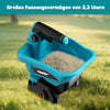 A blue cordless handheld spreader tool filled with white granules, placed outdoors on green grass.
