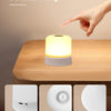 A white touch night light table lamp is shown on a wooden surface with close-ups of its components.
