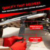 A hand in a red glove is holding a black heavy-duty poly webbing strap used for cargo securing.