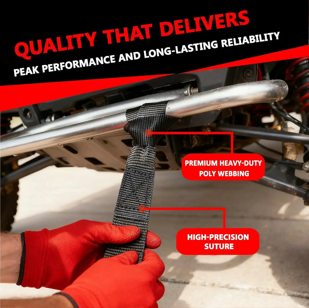 A hand in a red glove is holding a black heavy-duty poly webbing strap used for cargo securing.