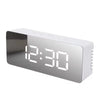 A modern digital weather station clock with a silver casing and white LED display showing the time 12:30.