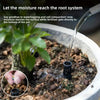 A close-up of a hand inserting plant aeration tubes into potting soil to deliver moisture and fertilizer directly to the root