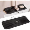 A black silicone sink splash mat is shown mounted on a white cabinet, with a coffee filter holder visible.
