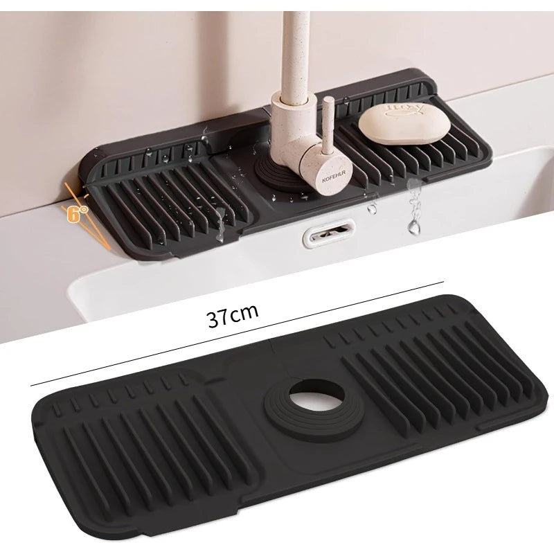 A black silicone sink splash mat is shown mounted on a white cabinet, with a coffee filter holder visible.