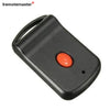 A black garage door remote transmitter with an orange button and a loop for a key.