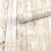 A roll of retro wood grain self-adhesive wall stickers lying on a light wooden floor.