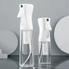 A pair of white high-pressure mist spray bottles for hair and makeup displayed on a gray surface.