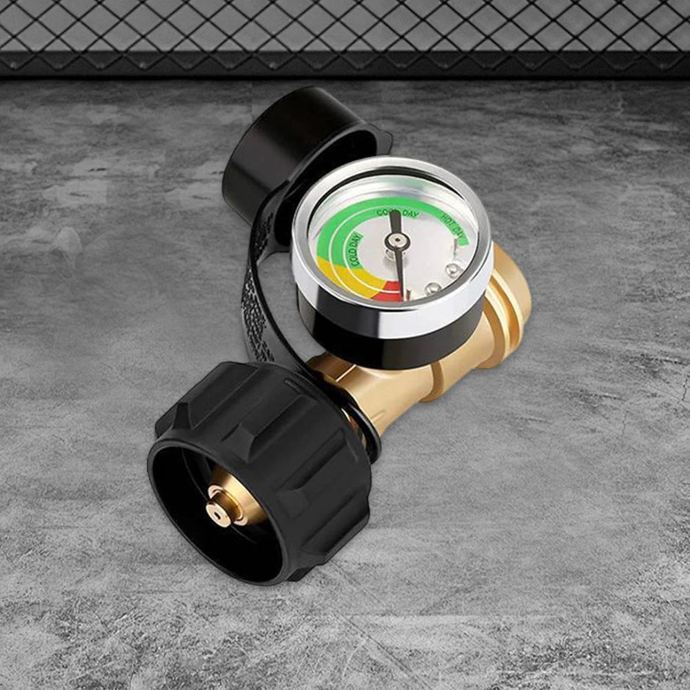 A close-up view of a black propane tank pressure gauge with a clear dial and brass fitting.