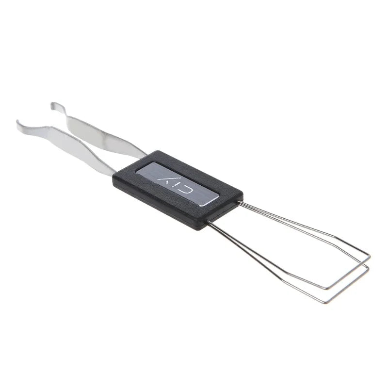 A black key extractor tool with metal wires for removing mechanical keyboard switches.