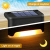 A solar powered deck light showing the device both charging during the day and illuminating a pathway at night.