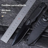 A black outdoor survival knife with a visible blade and handle, shown next to a ruler.