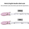 Pink double-sided metric and English measuring tape showing centimeter and foot scales