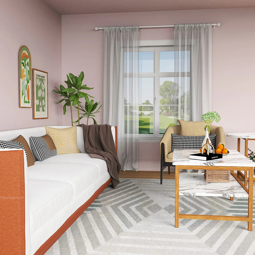 A light pink room features a white sofa and a window with sheer gray curtains.