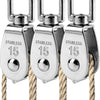 Three stainless steel wire rope pulley blocks hanging from thick natural fiber rope.