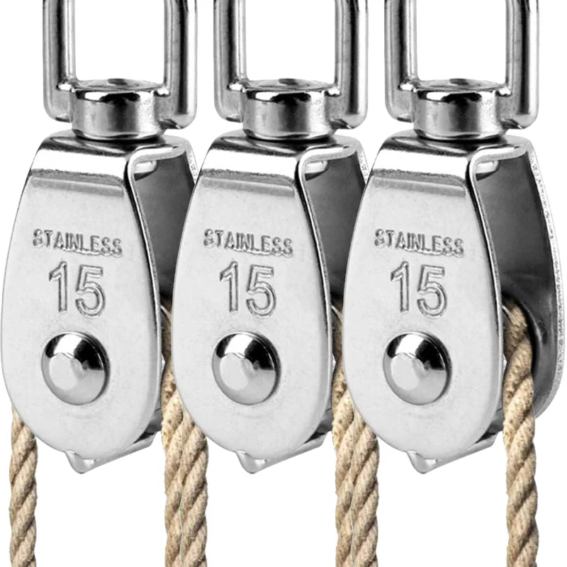 Three stainless steel wire rope pulley blocks hanging from thick natural fiber rope.