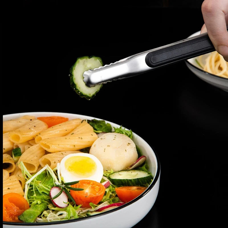 Stainless steel BBQ grill tongs with kitchen clips used to serve food
