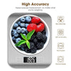 A silver digital kitchen scale measuring various fruits and vegetables.